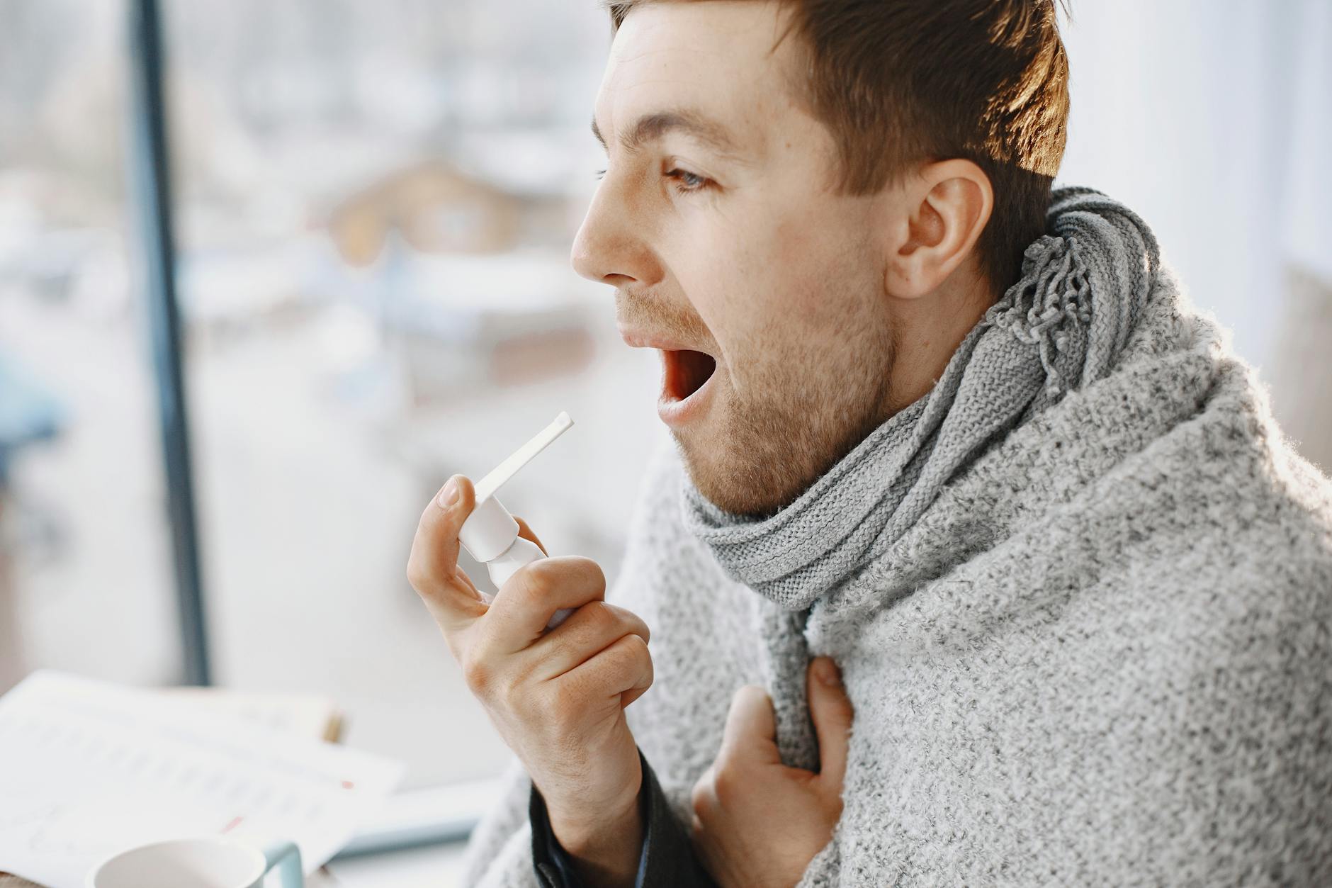 man taking medication for throat